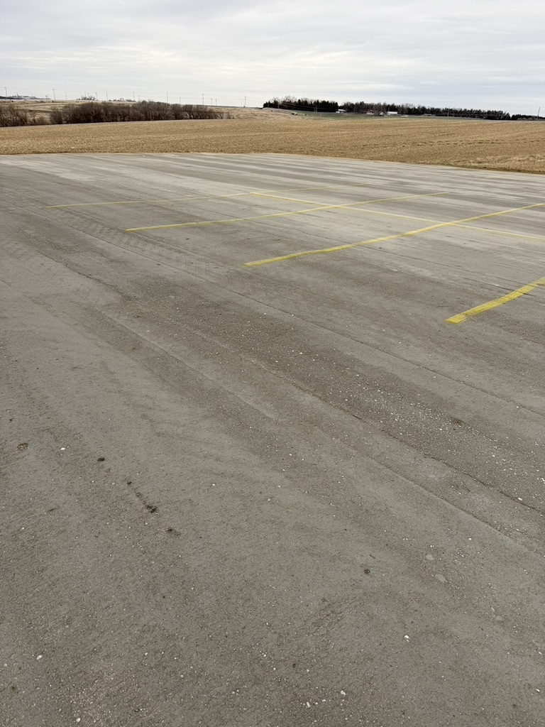 Roller compacted concrete parking area with marked spaces
